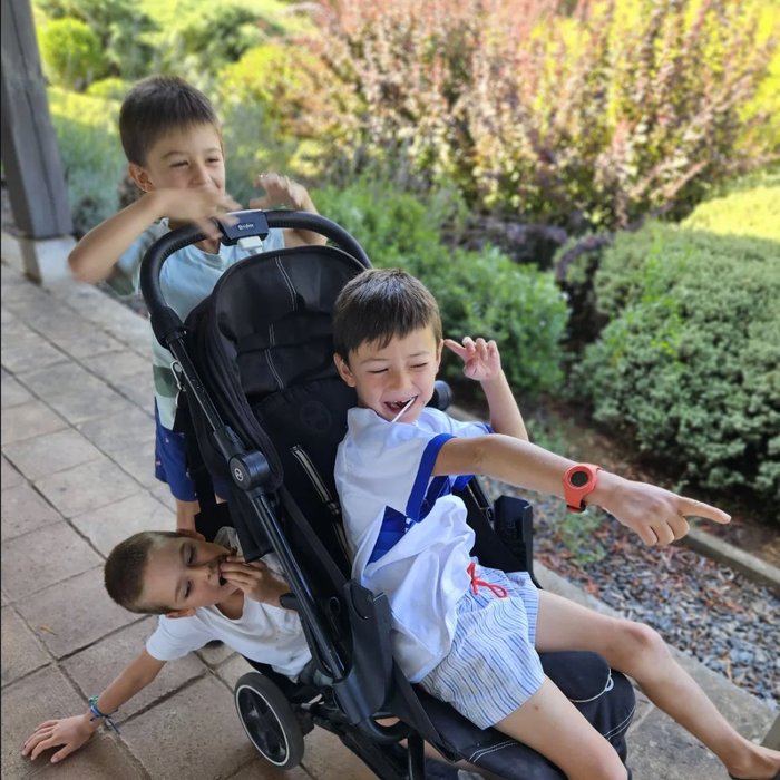 Tres niños jugando y riendo con el coche Pepe Pillo
